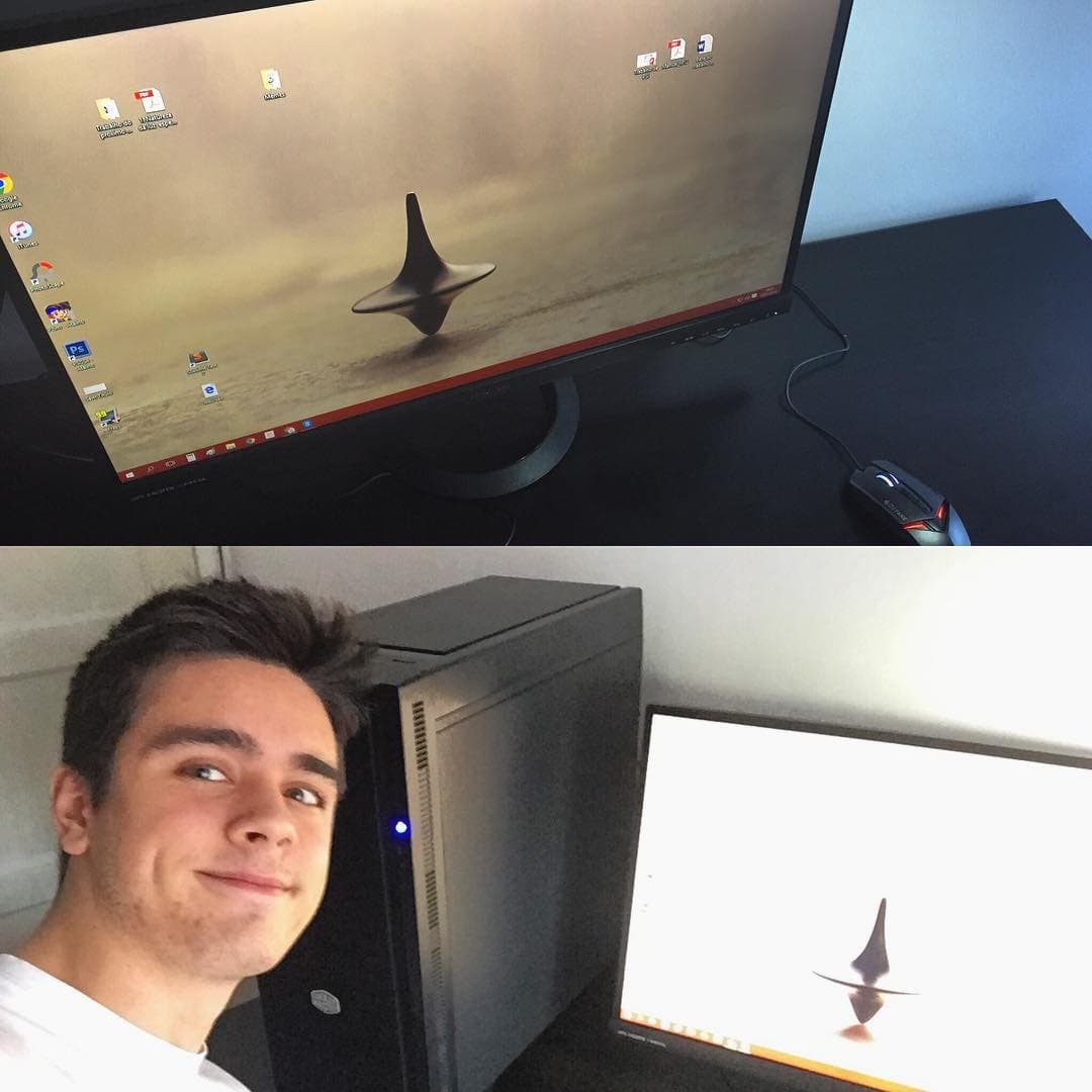 The finished computer on a desk, and Rodrigo smiling next to it