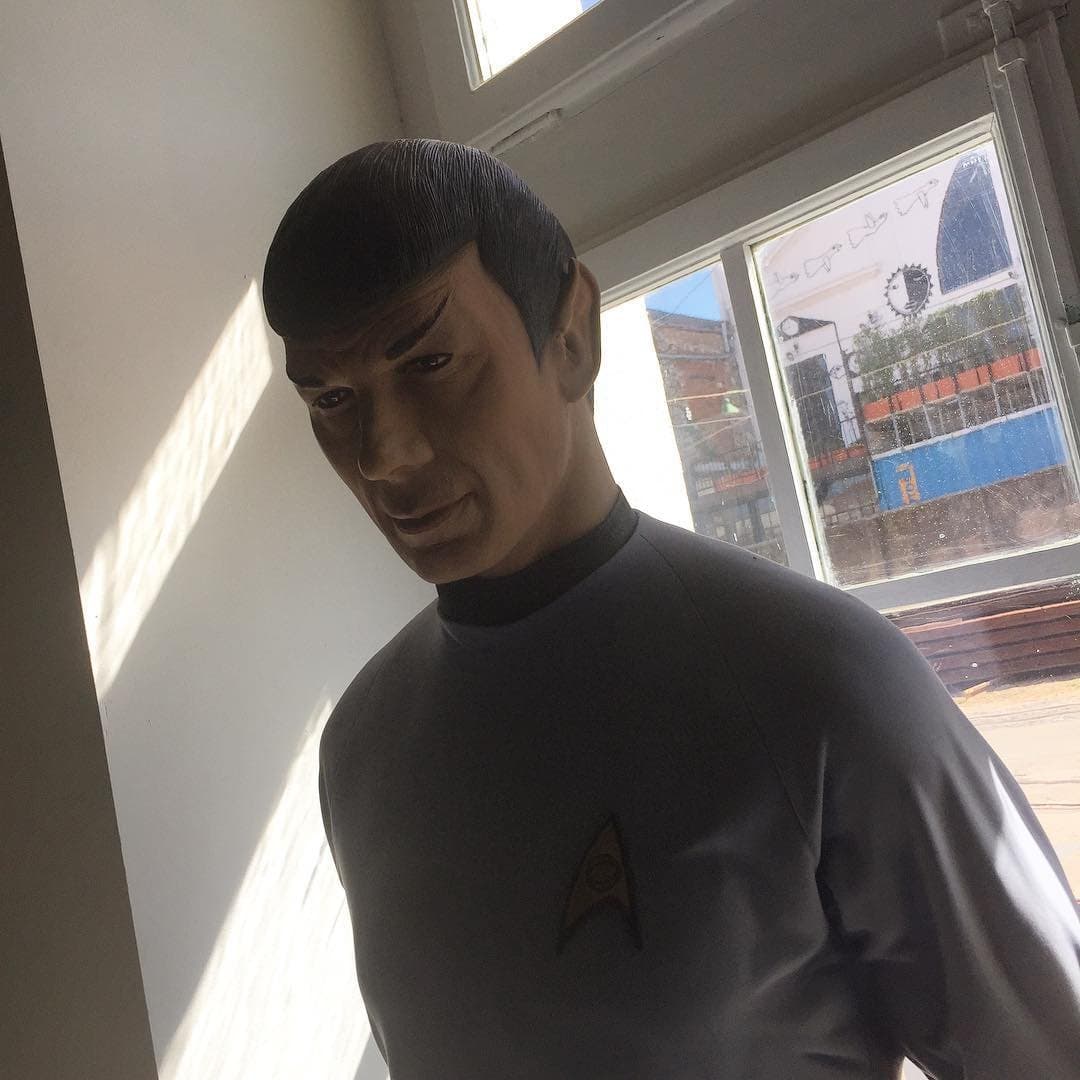 A life-size Spock figure standing by a sunny window
